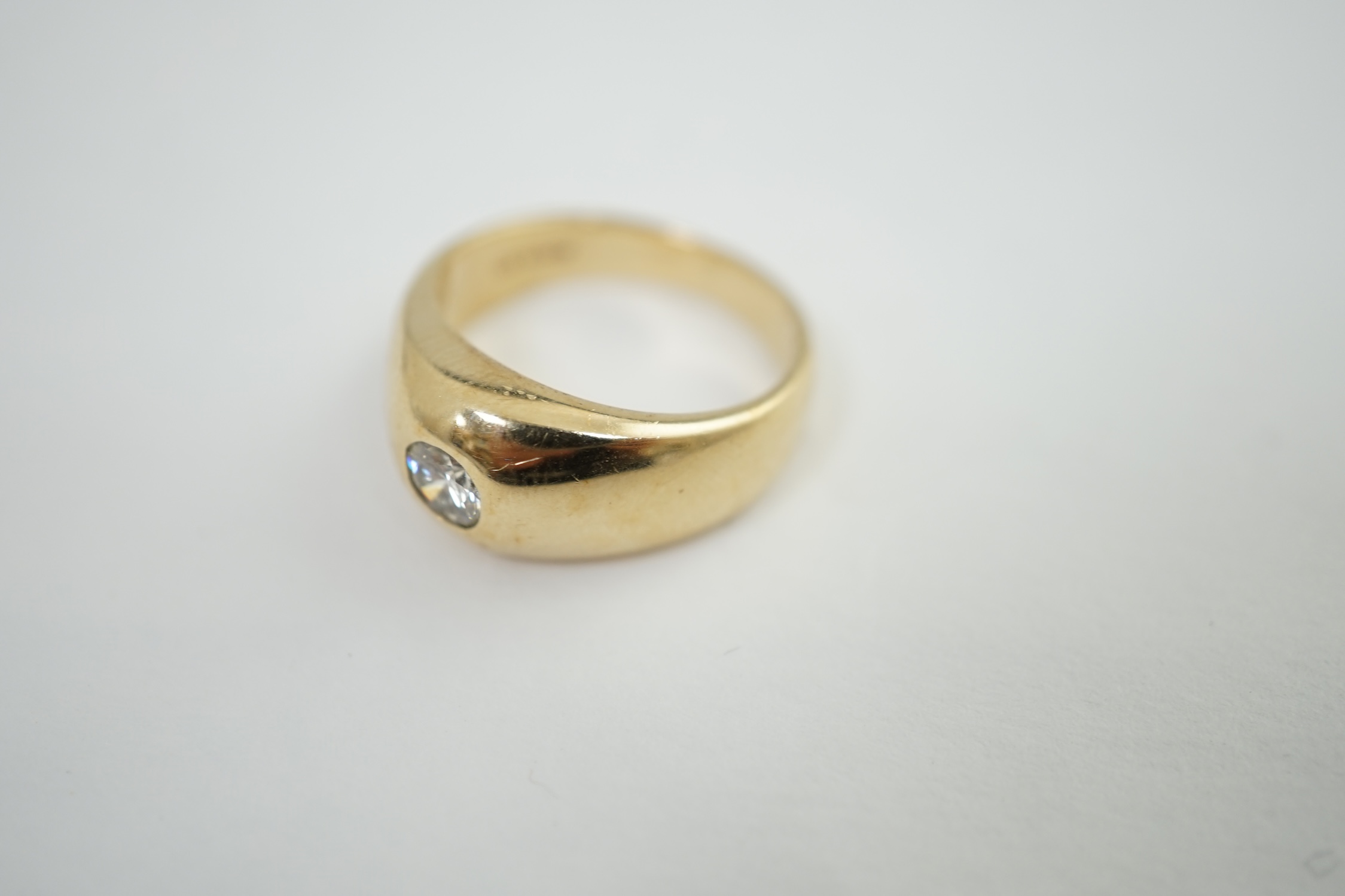 A modern 9ct gold and collet set solitaire diamond ring